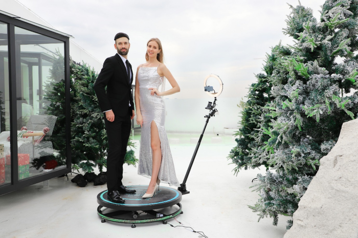 A couple standing on 360 photo booth